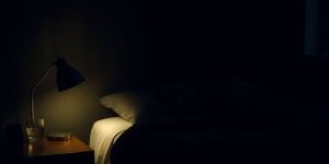 Peaceful bedroom, soft lighting, person sleeping soundly.